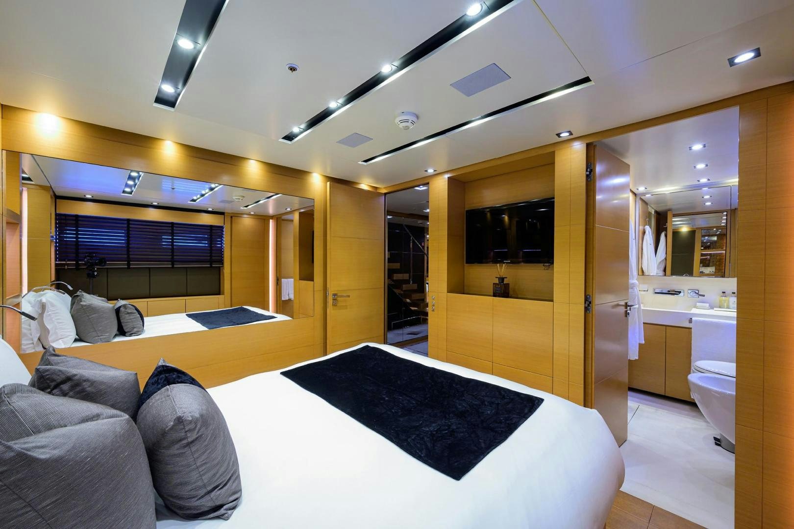 a room with a bed and a couch aboard AWAY Yacht for Sale