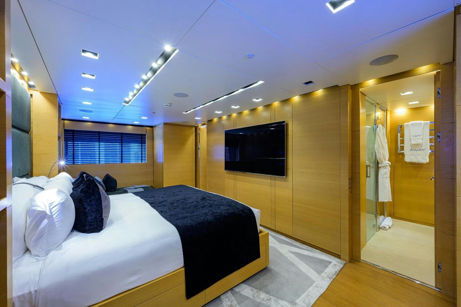 a room with a bed and a television aboard AWAY Yacht for Sale