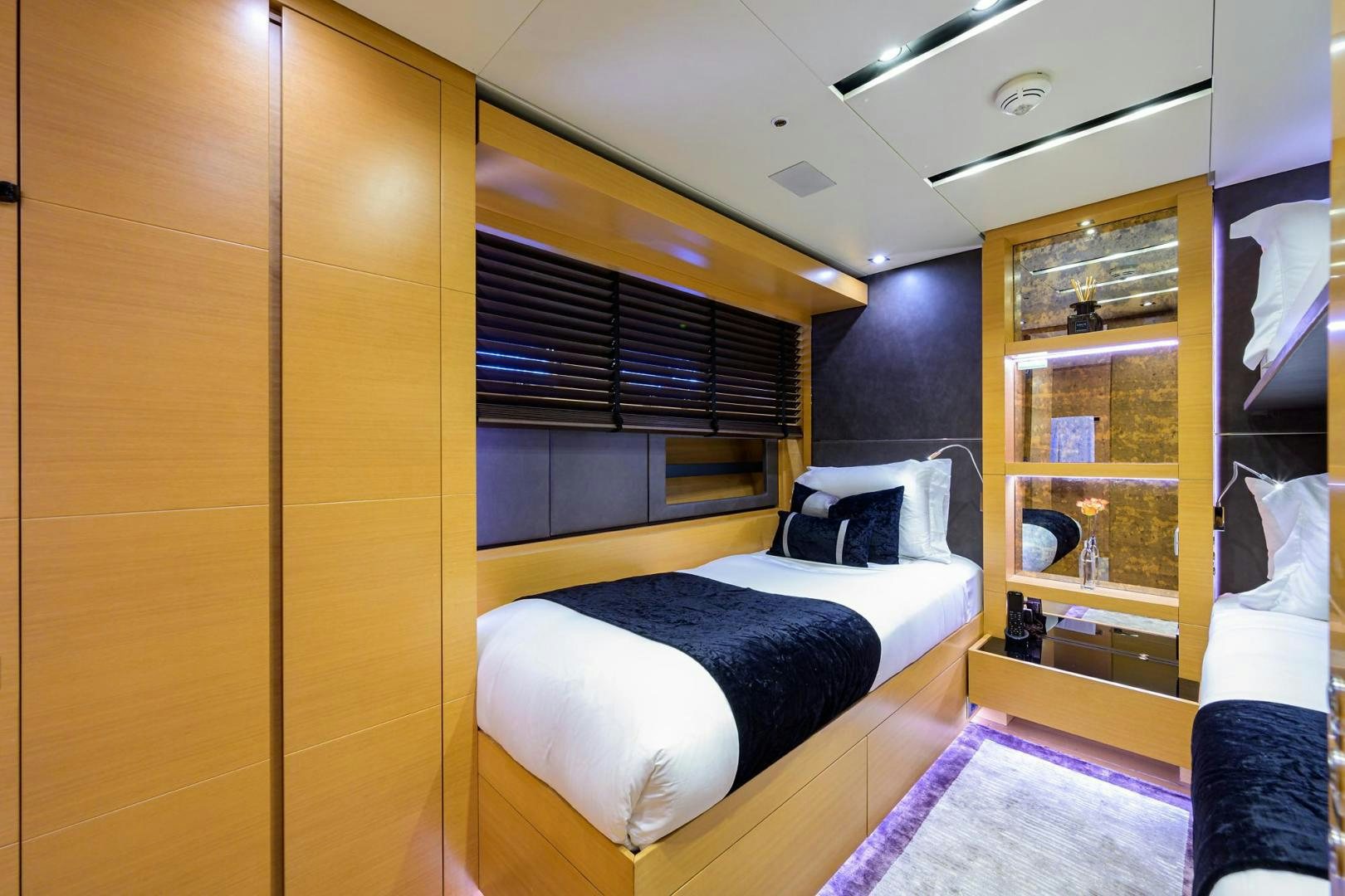 a bedroom with a bed and a closet aboard AWAY Yacht for Sale