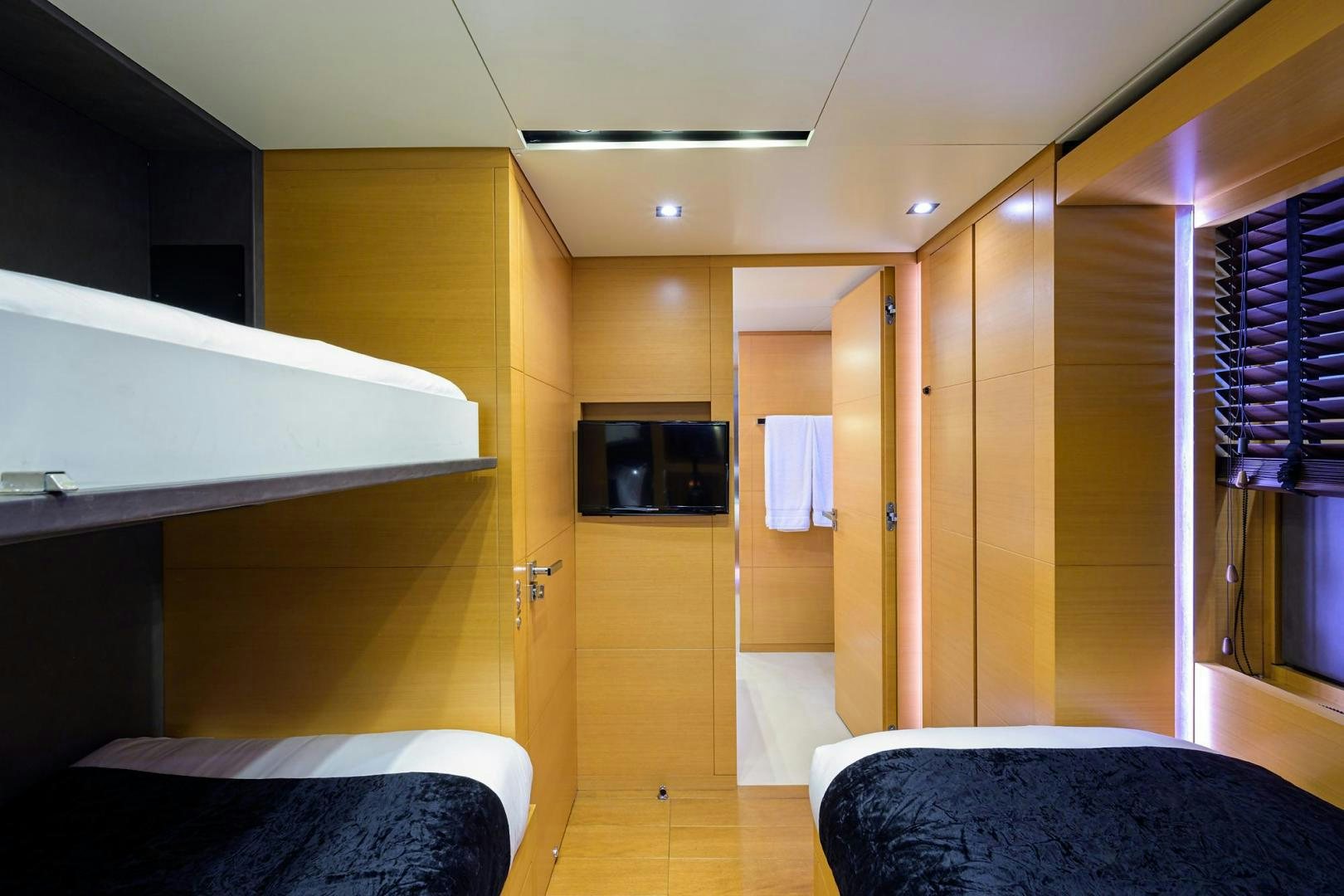 a room with a bed and a tv aboard AWAY Yacht for Sale