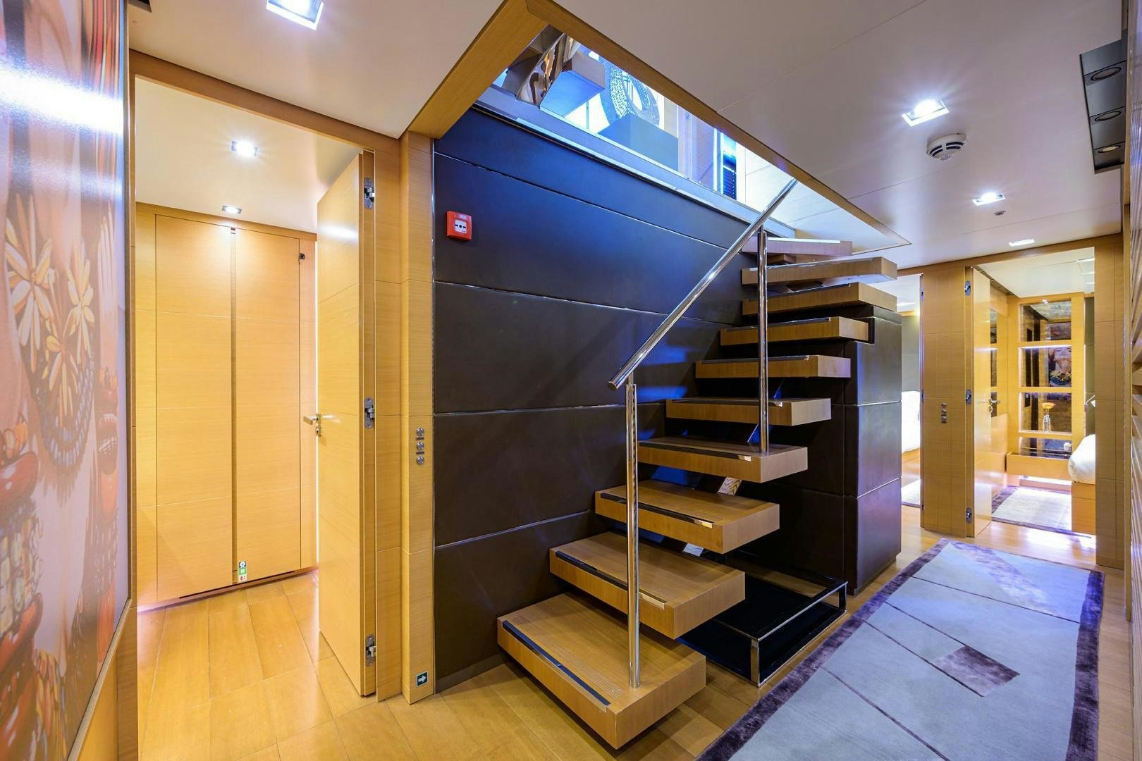 a room with a staircase and a large glass window aboard AWAY Yacht for Sale