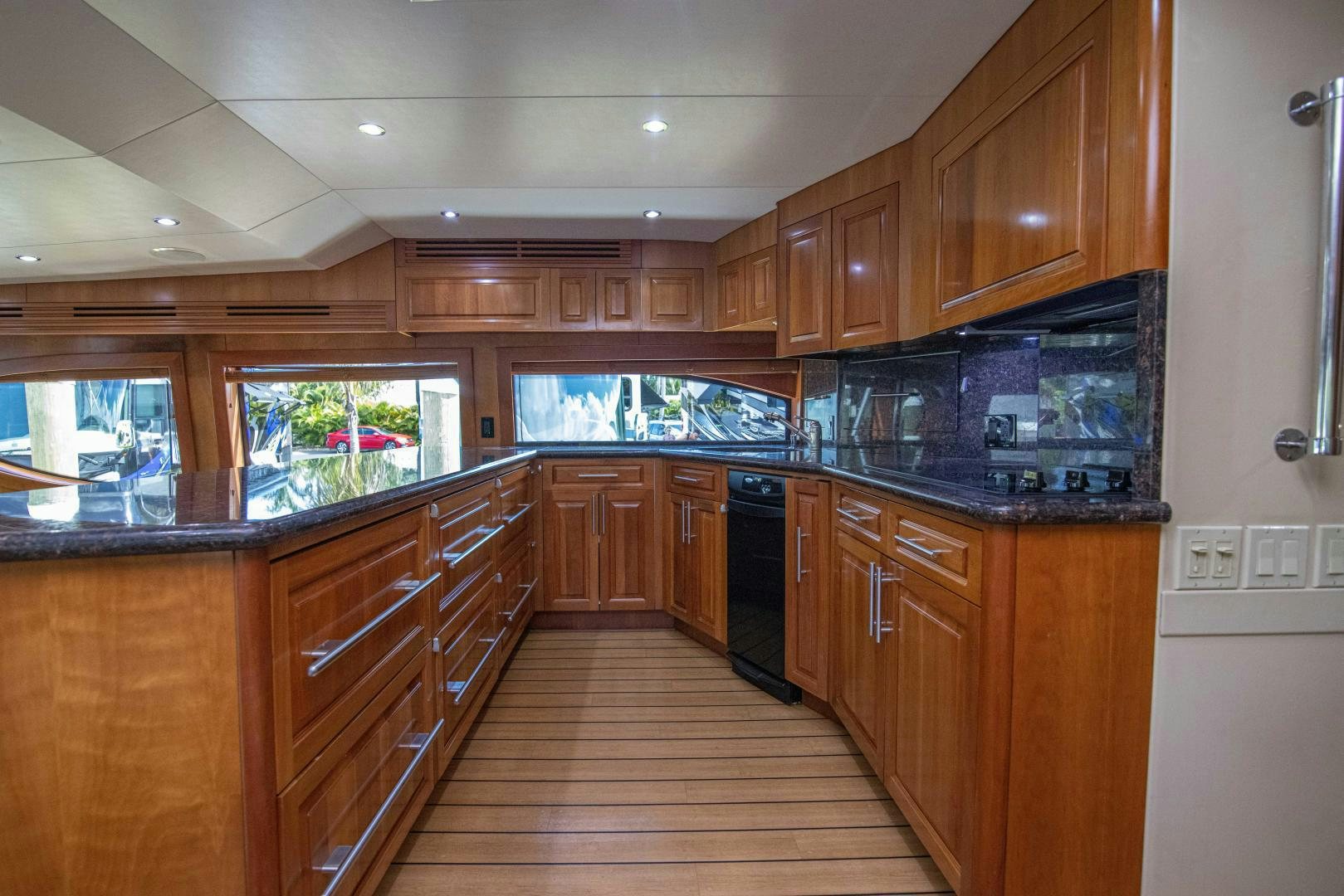 a large kitchen with wooden cabinets aboard IONA LOUISE Yacht for Sale