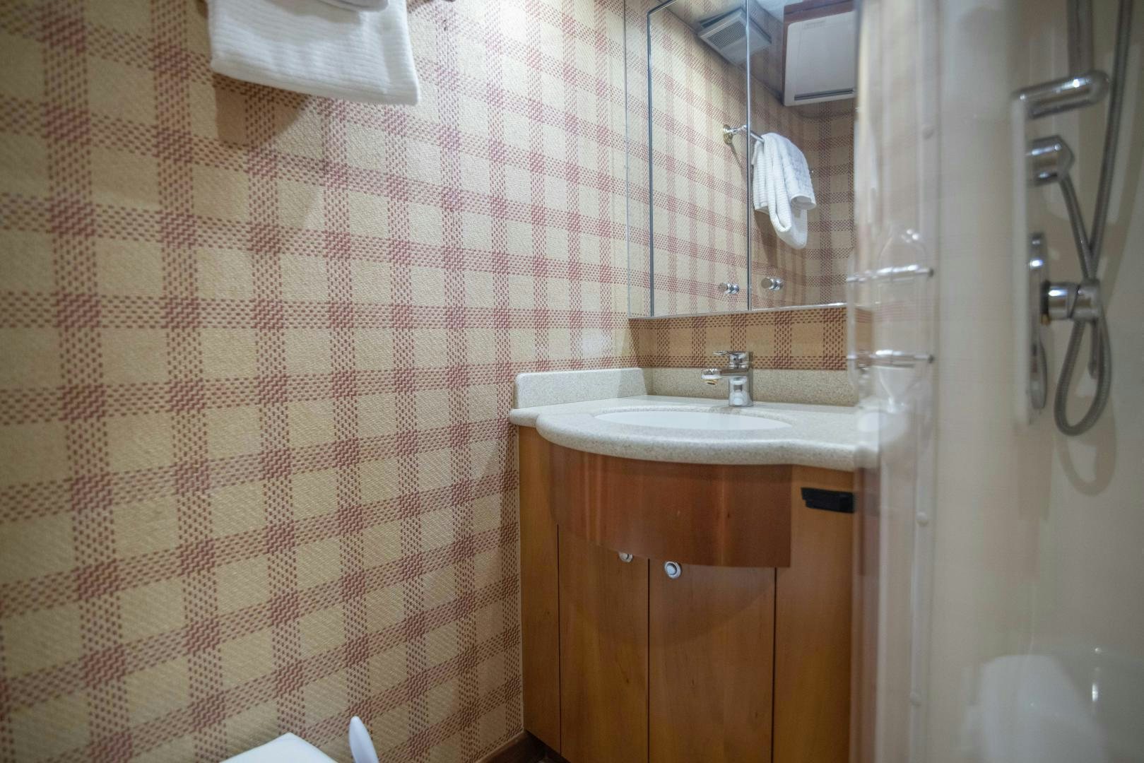 a bathroom with a sink and shower aboard IONA LOUISE Yacht for Sale