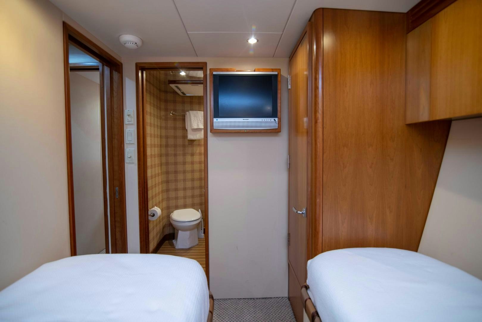a bathroom with a bed and a television aboard IONA LOUISE Yacht for Sale
