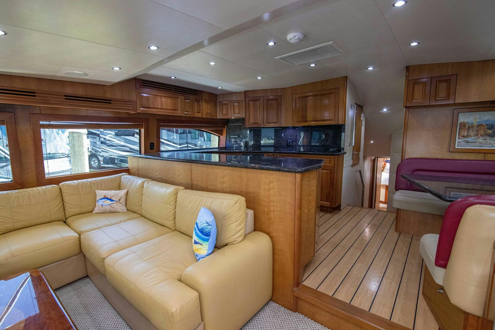 a living room with a couch and a kitchen in the background aboard IONA LOUISE Yacht for Sale