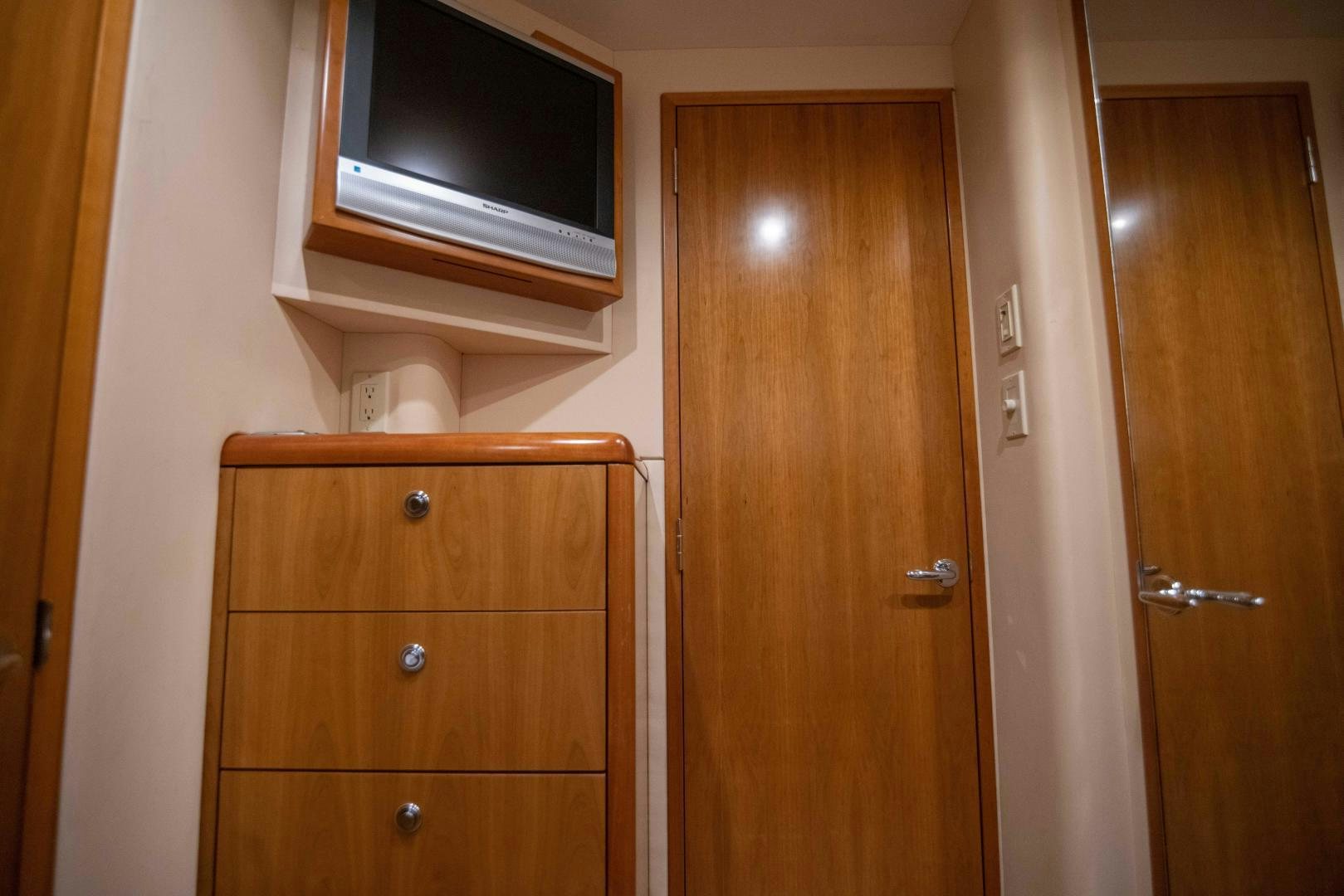 a room with wooden cabinets aboard IONA LOUISE Yacht for Sale