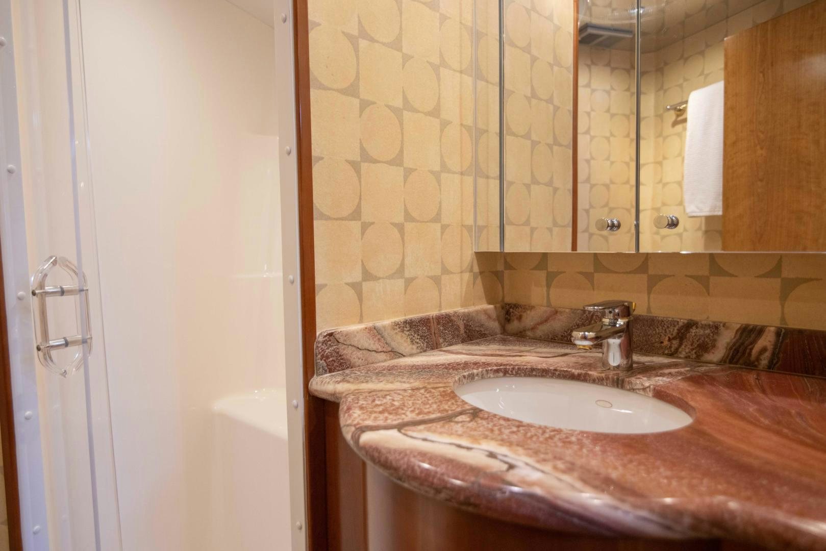 a bathroom with a sink and a mirror aboard IONA LOUISE Yacht for Sale