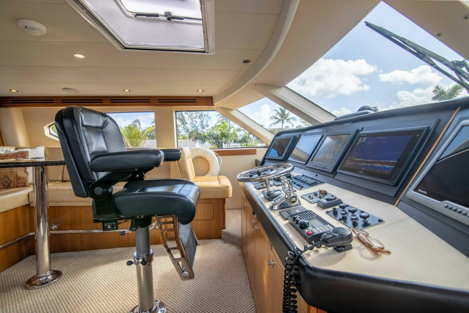a car with a computer and a chair in the back aboard IONA LOUISE Yacht for Sale