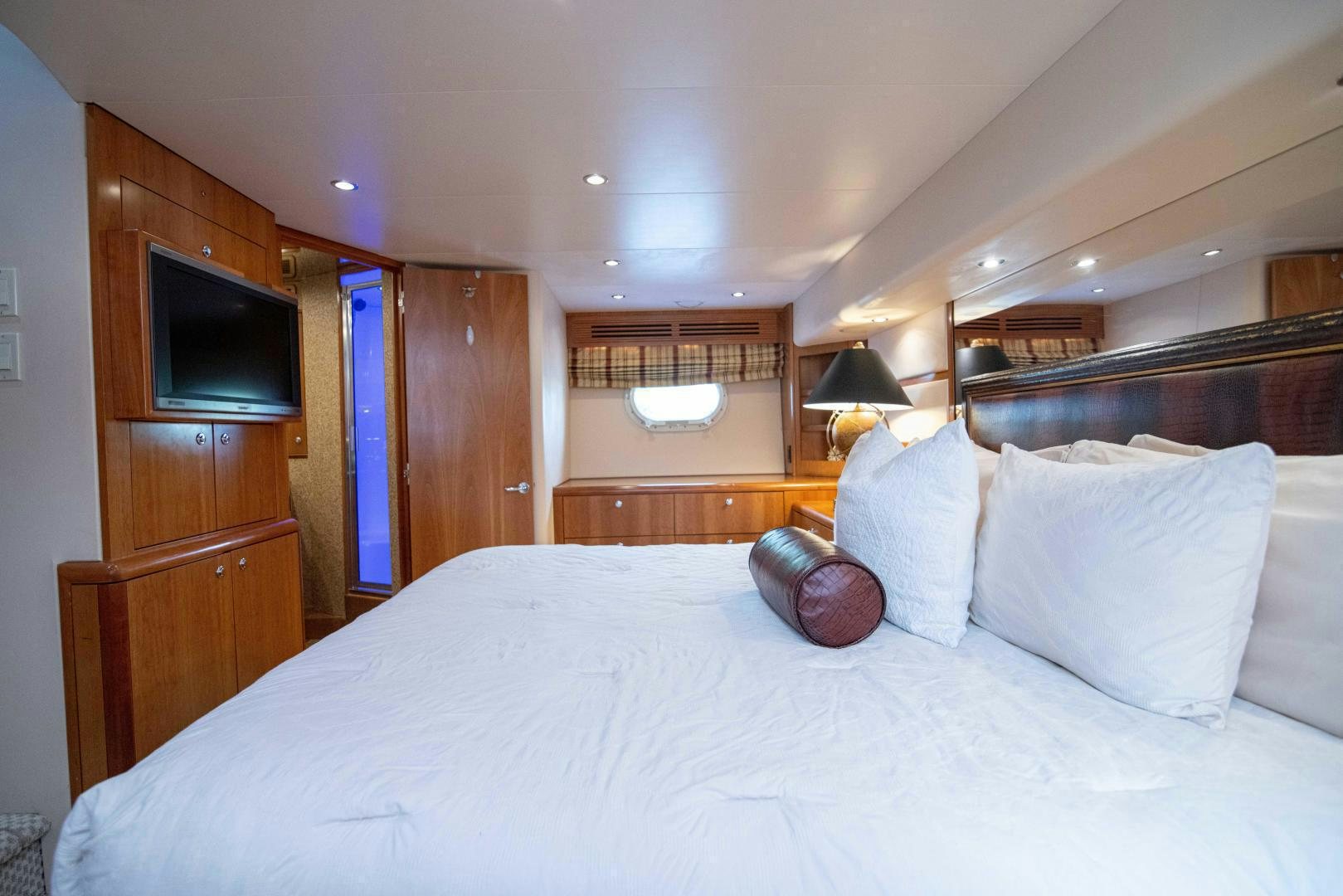 a bed with white sheets and pillows aboard IONA LOUISE Yacht for Sale