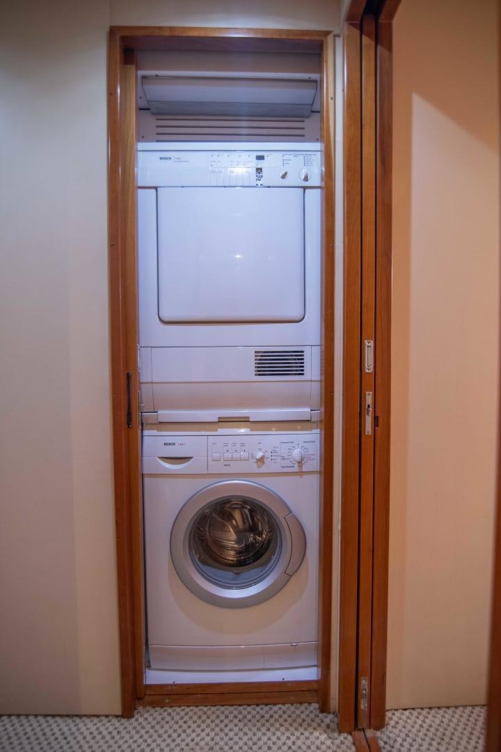 a closet with a washing machine aboard IONA LOUISE Yacht for Sale