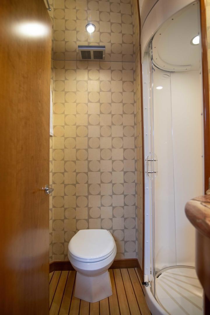 a bathroom with a toilet and a shower aboard IONA LOUISE Yacht for Sale
