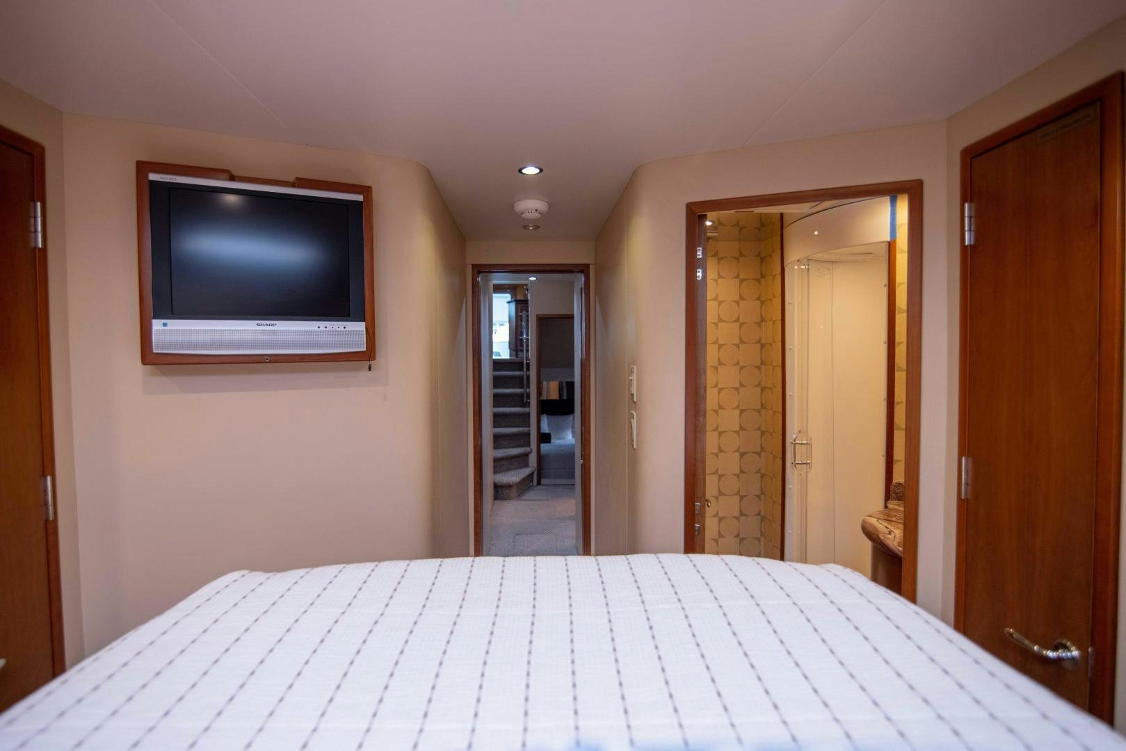 a large flat screen television on a wall in a room with a door aboard IONA LOUISE Yacht for Sale