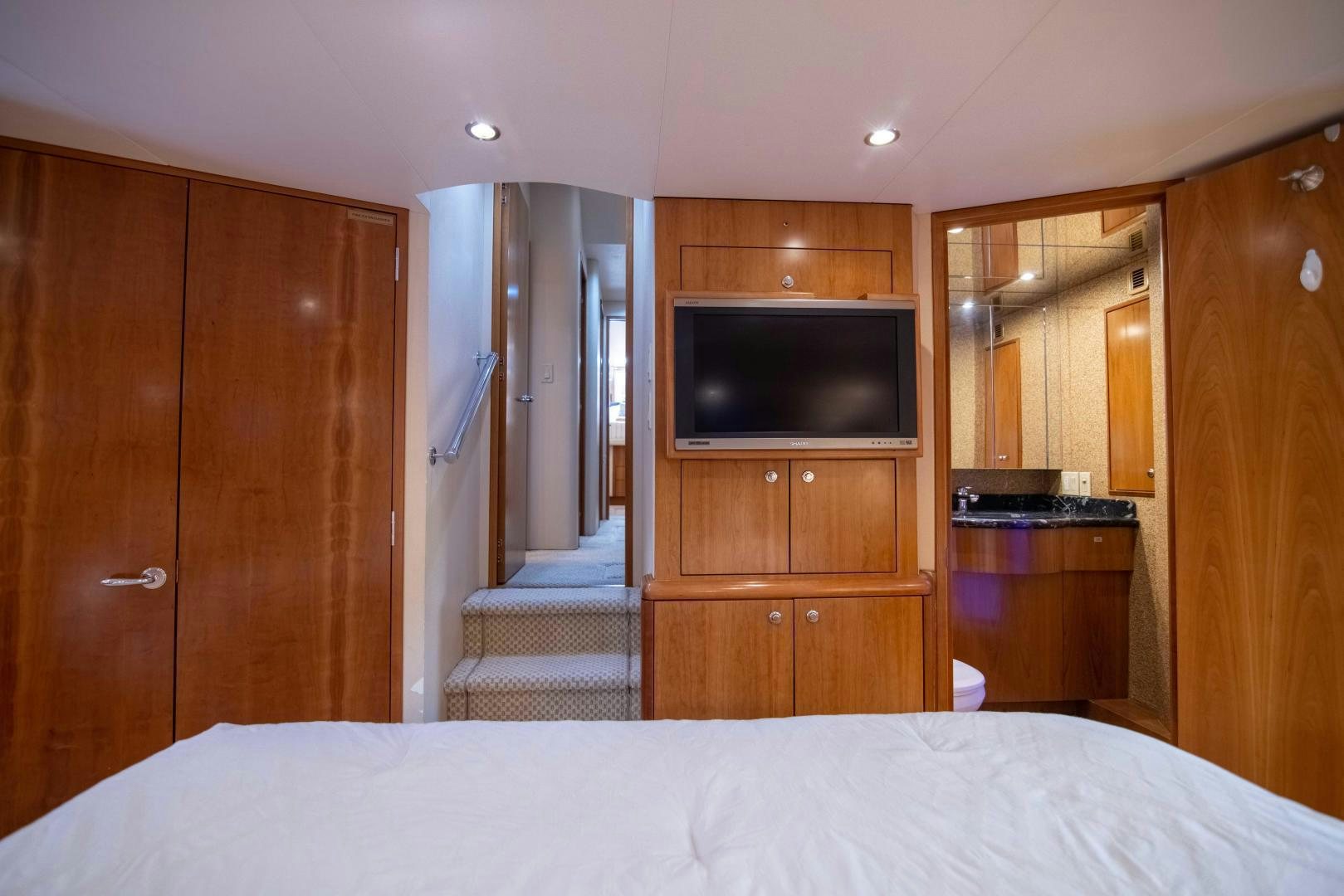 a bedroom with a bed and a television aboard IONA LOUISE Yacht for Sale