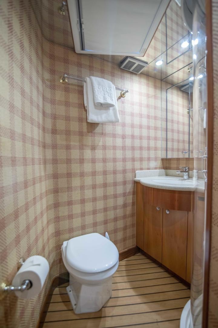 a bathroom with a toilet and sink aboard IONA LOUISE Yacht for Sale