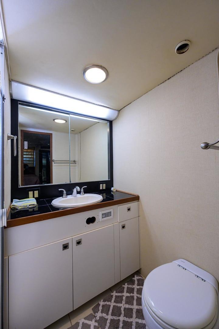 a bathroom with a toilet and a sink aboard CHRISTIE LEE Yacht for Sale