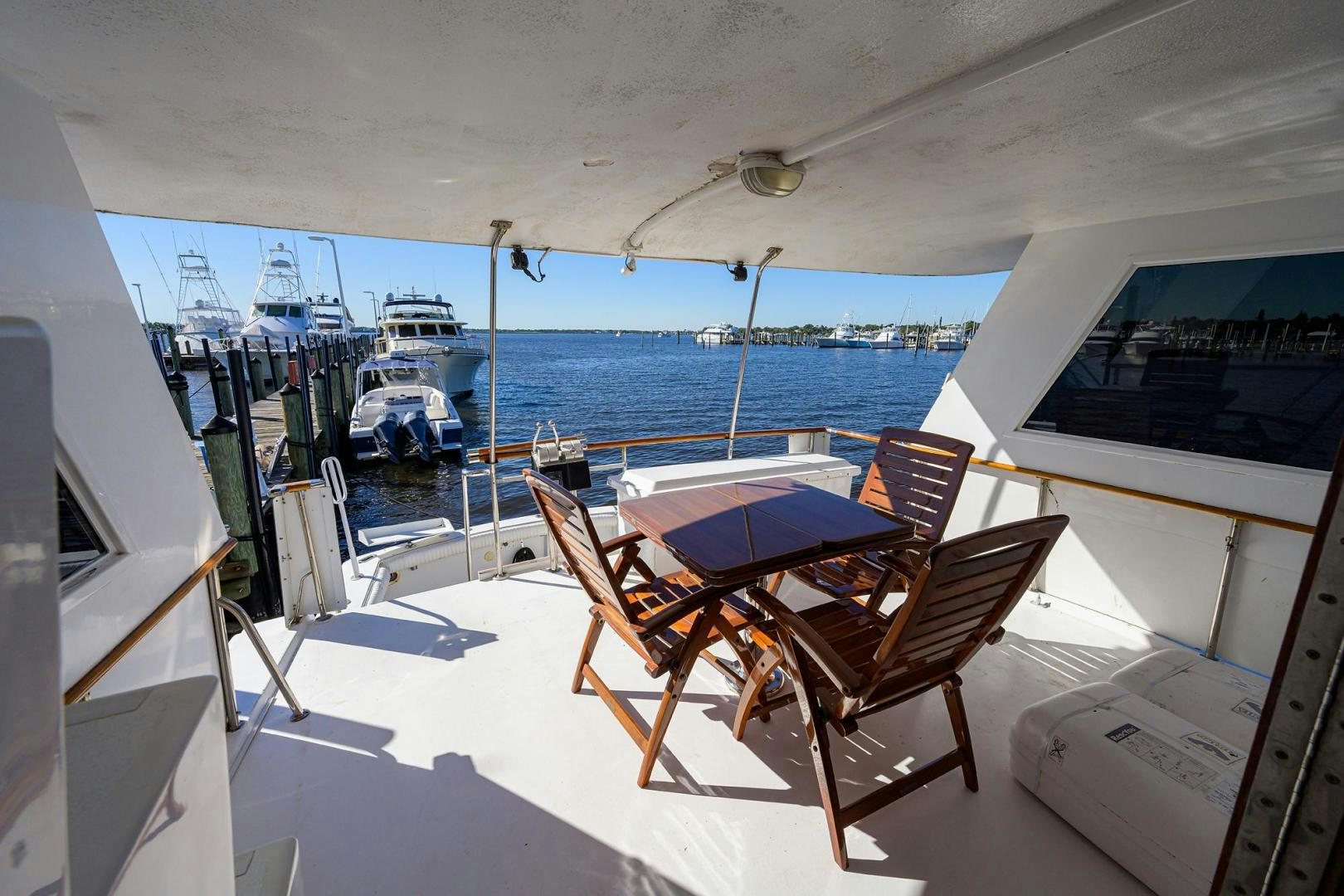 a deck with chairs and tables on it aboard CHRISTIE LEE Yacht for Sale