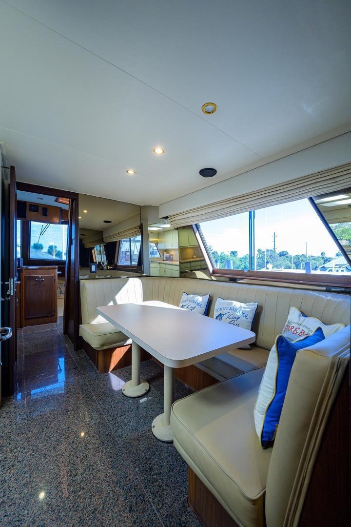 a room with a table and chairs aboard CHRISTIE LEE Yacht for Sale