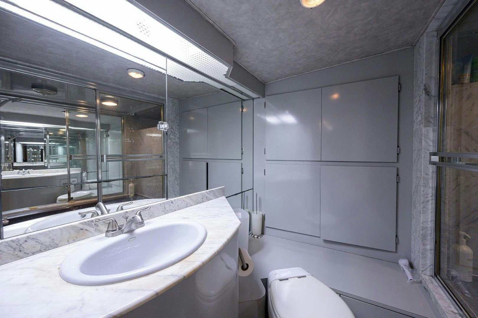a bathroom with a large mirror aboard CHRISTIE LEE Yacht for Sale