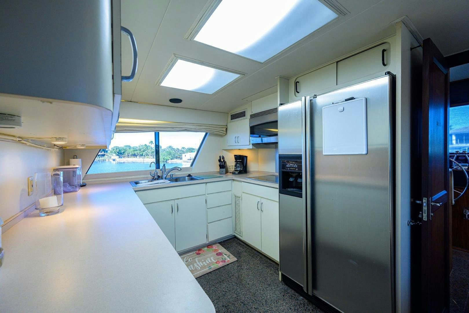 a kitchen with a refrigerator and a sink aboard CHRISTIE LEE Yacht for Sale