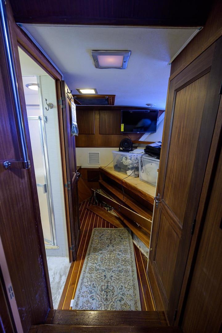 a room with a wood door and a wood cabinet aboard CHRISTIE LEE Yacht for Sale