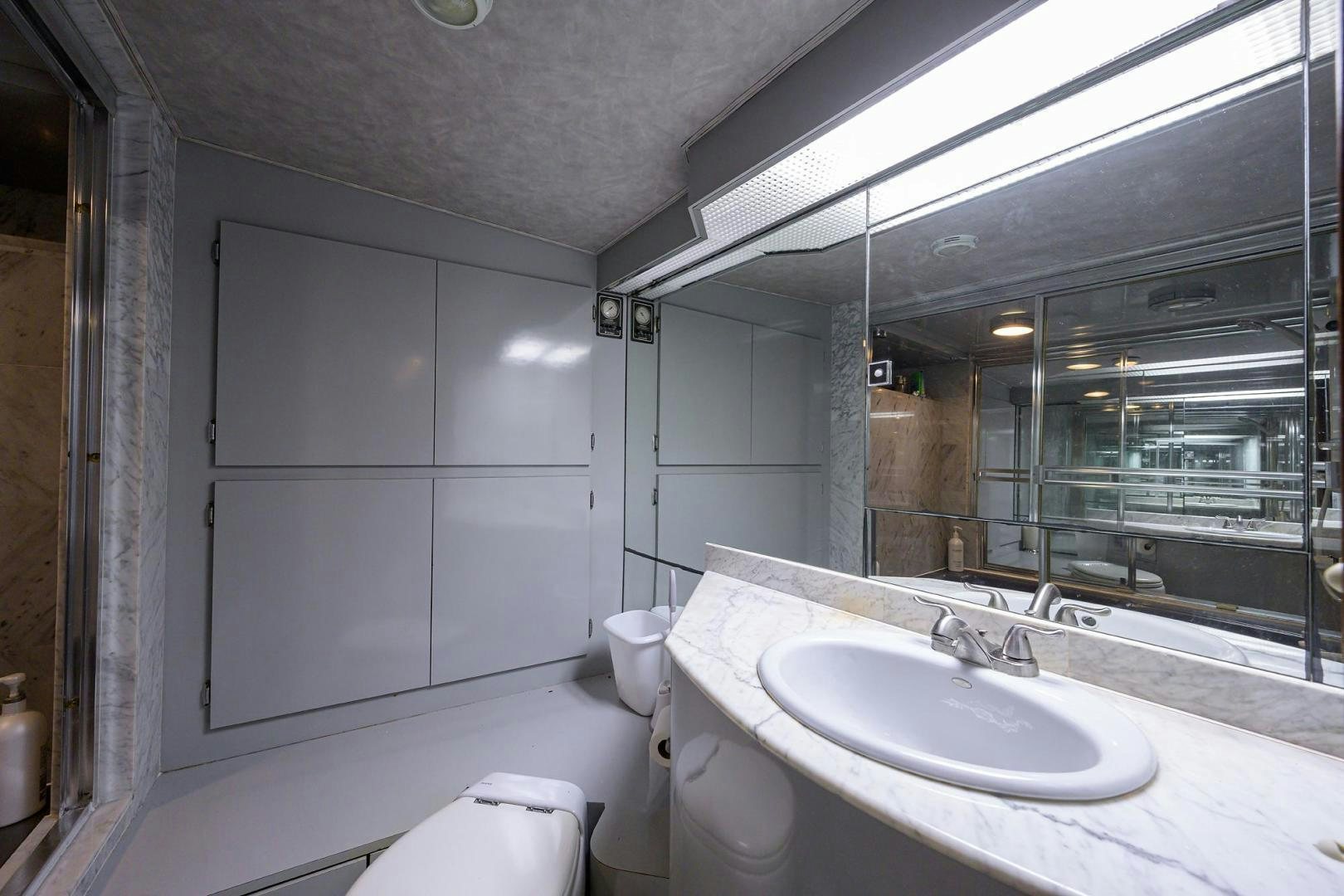 a bathroom with a large mirror aboard CHRISTIE LEE Yacht for Sale