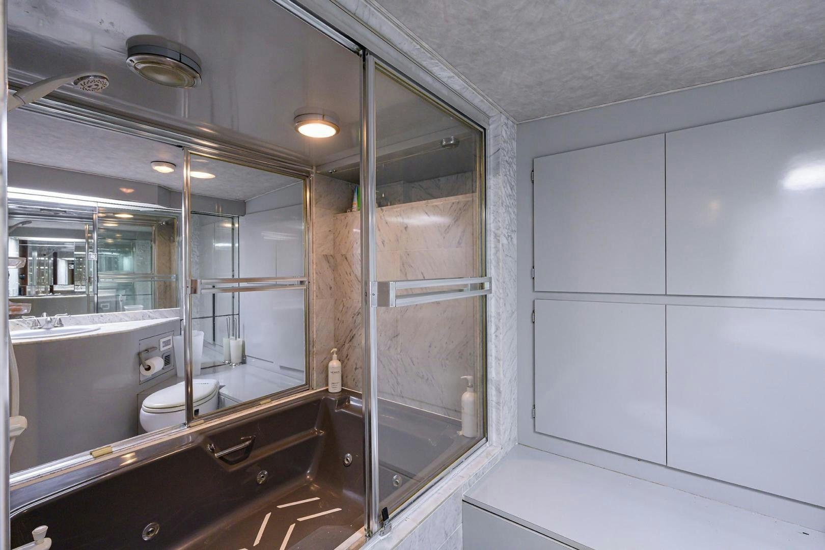 a bathroom with a glass shower aboard CHRISTIE LEE Yacht for Sale