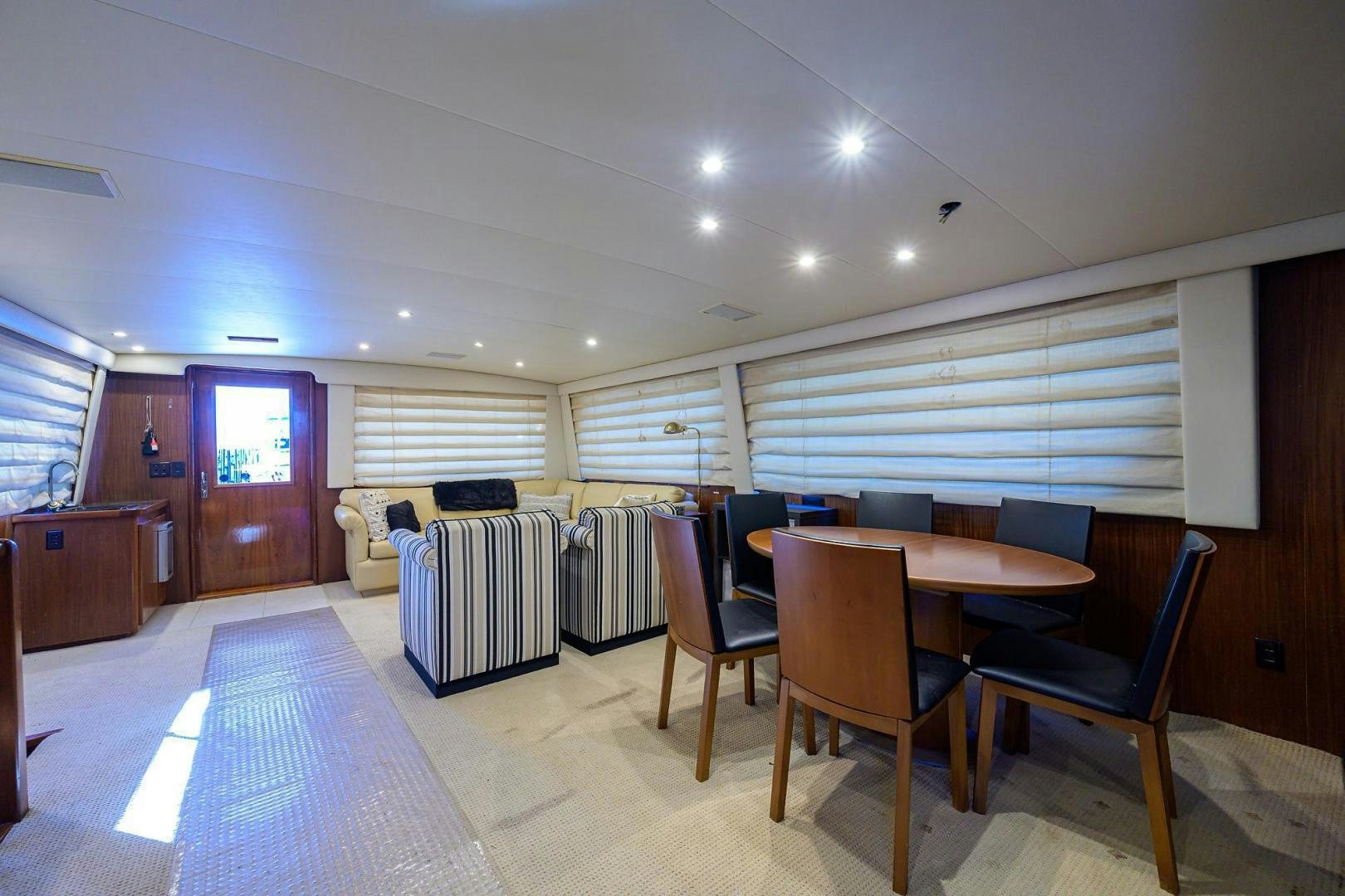 a room with a table chairs and a window aboard CHRISTIE LEE Yacht for Sale