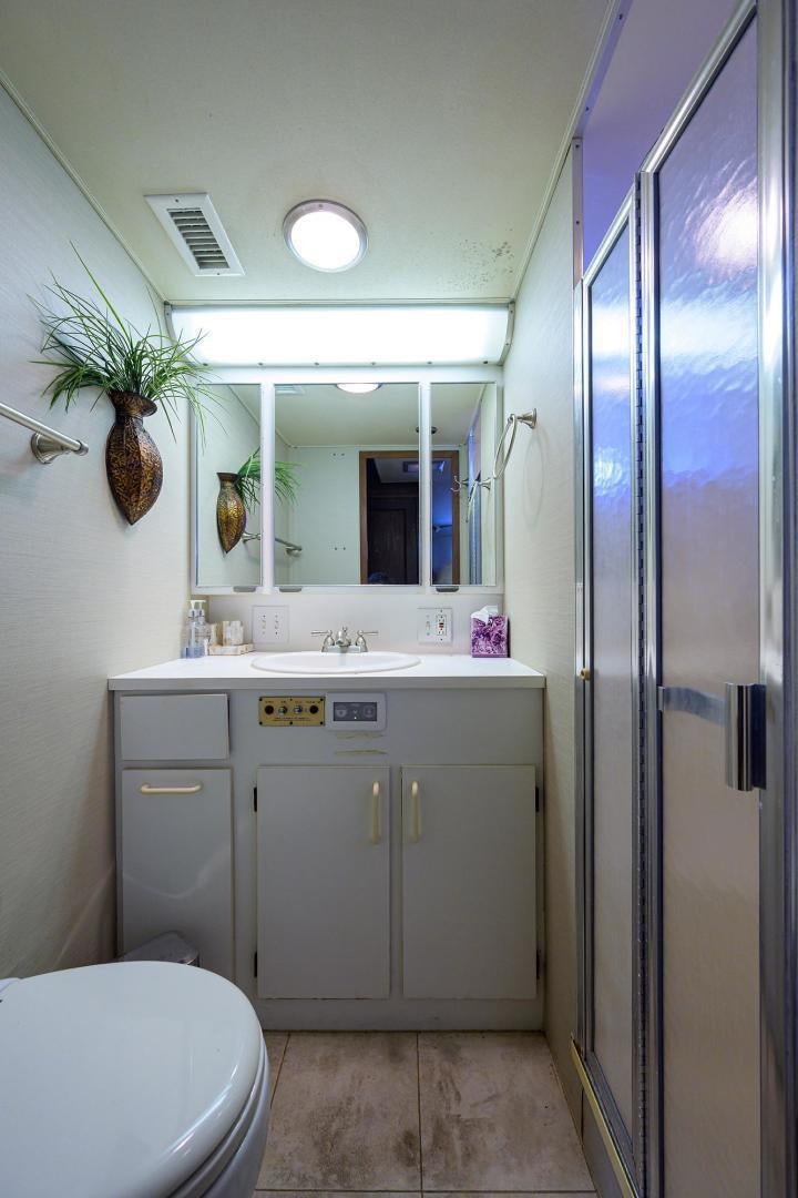 a bathroom with a sink and toilet aboard CHRISTIE LEE Yacht for Sale