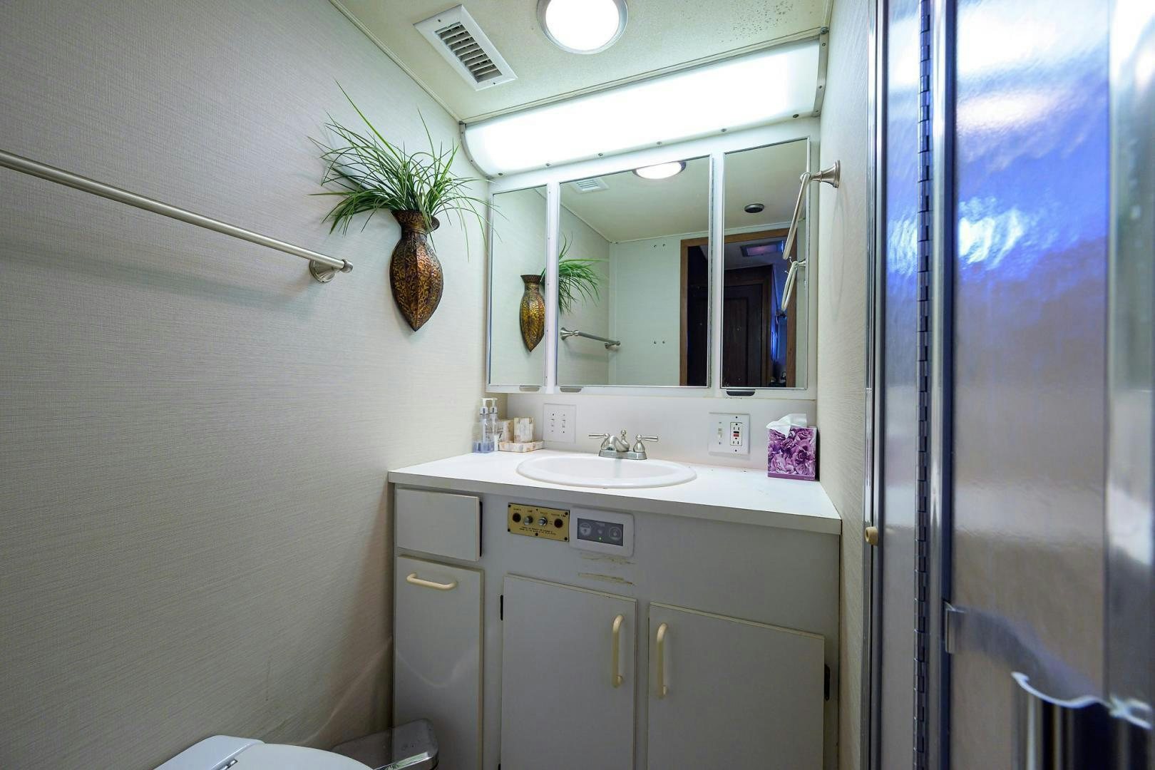 a bathroom with a sink and mirror aboard CHRISTIE LEE Yacht for Sale