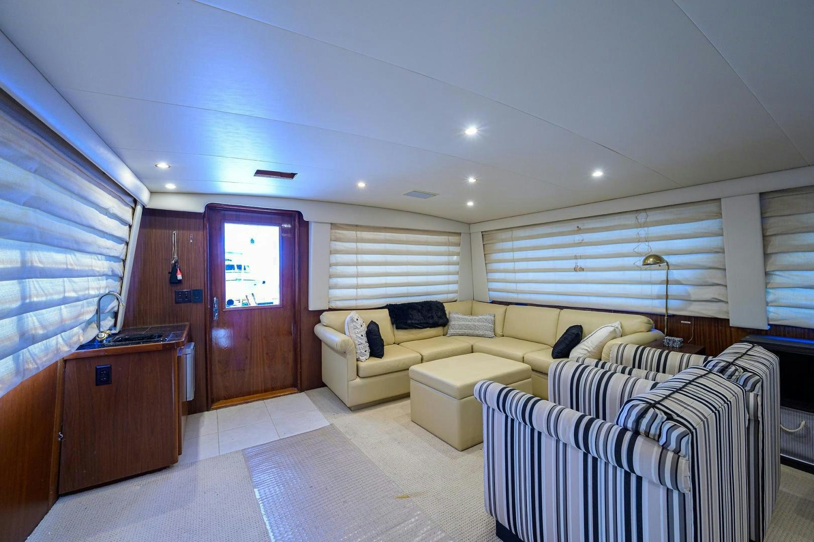 a living room with a couch and a television aboard CHRISTIE LEE Yacht for Sale