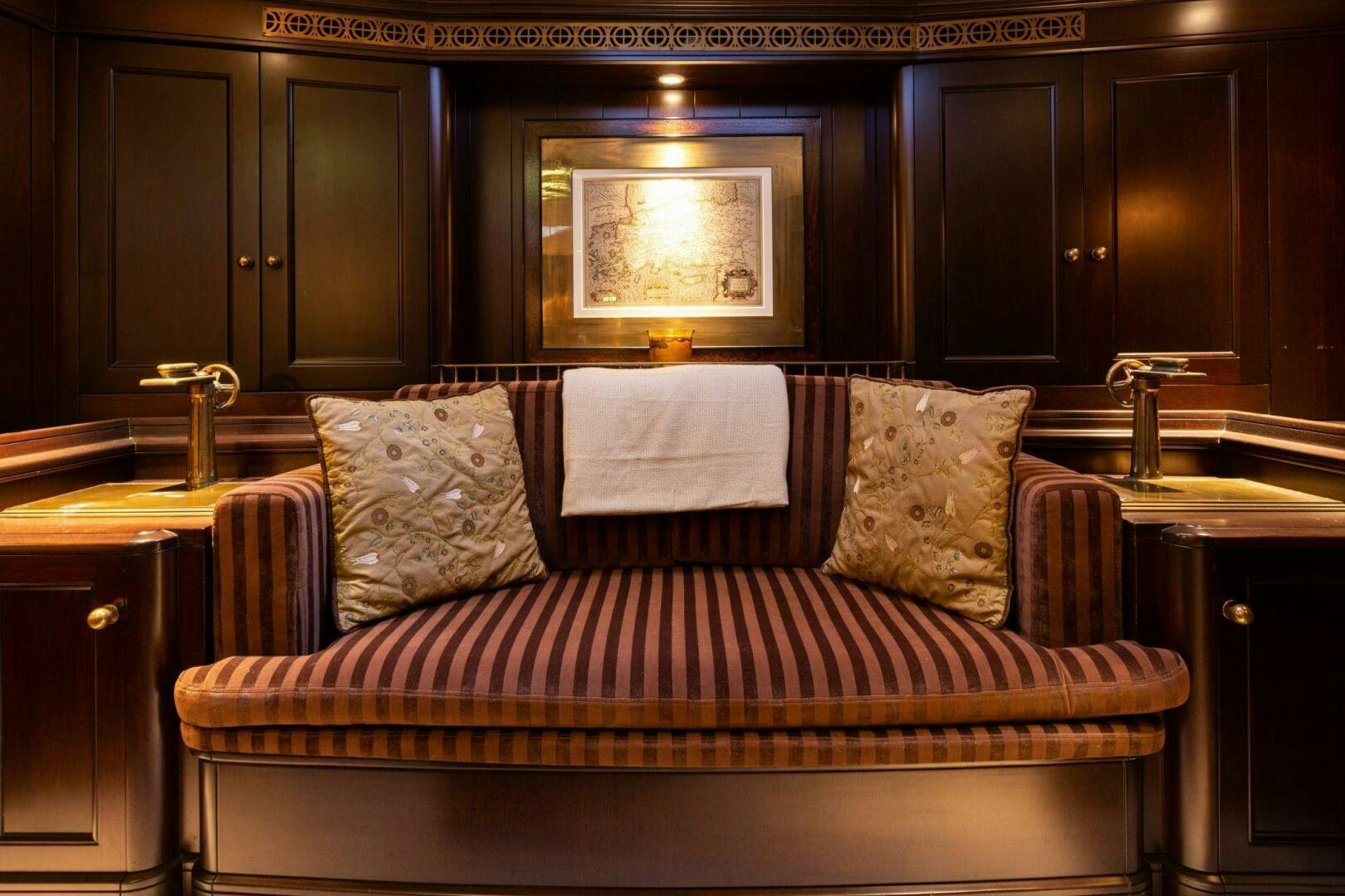 a bed with a pillow and a mirror above it aboard GWEILO Yacht for Sale