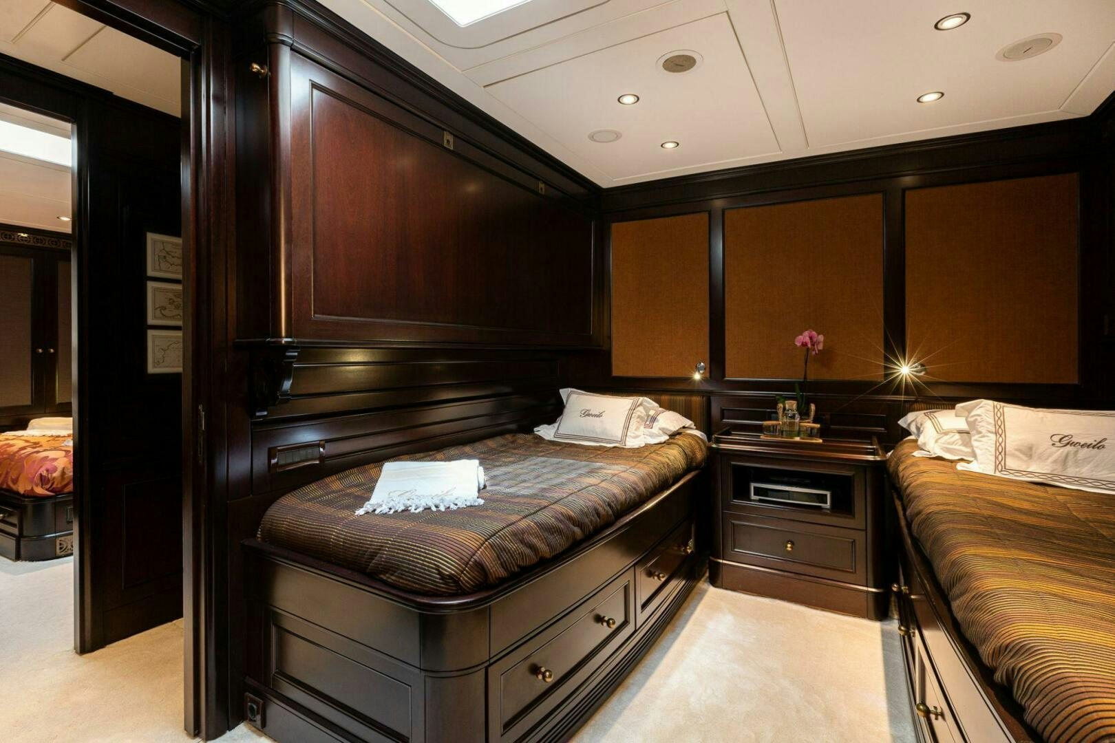 a bedroom with a bed and a dresser aboard GWEILO Yacht for Sale
