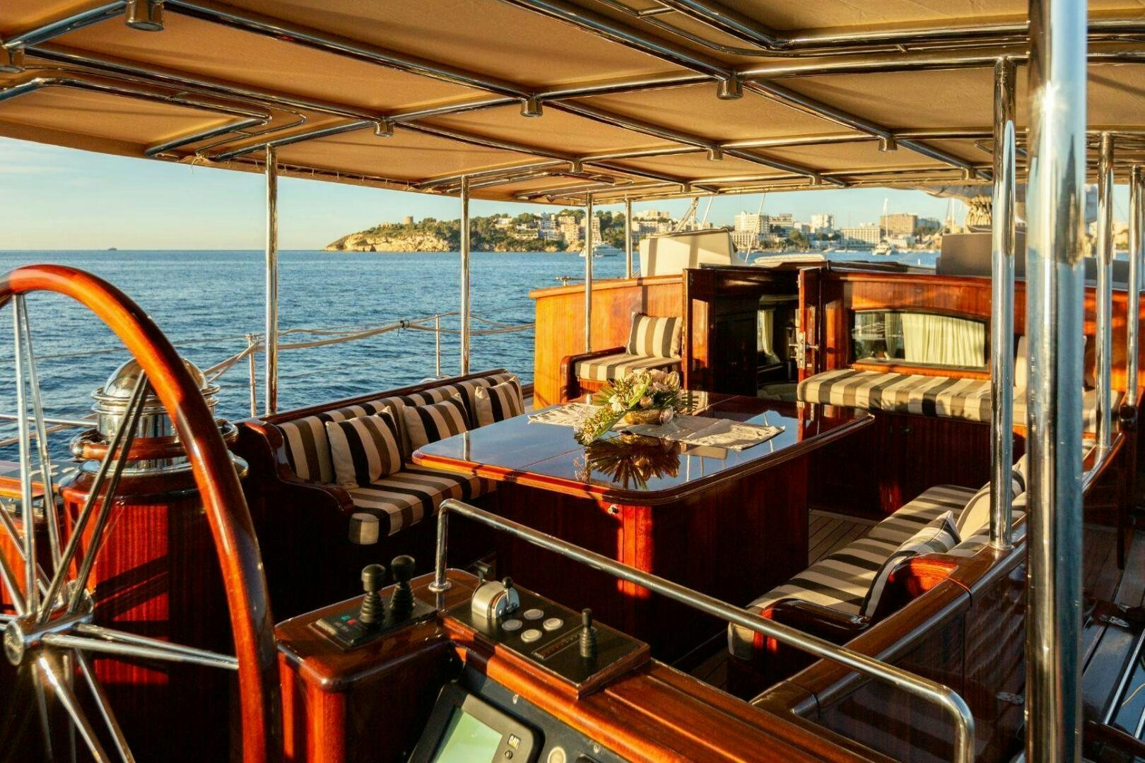 a boat with a table and chairs aboard GWEILO Yacht for Sale