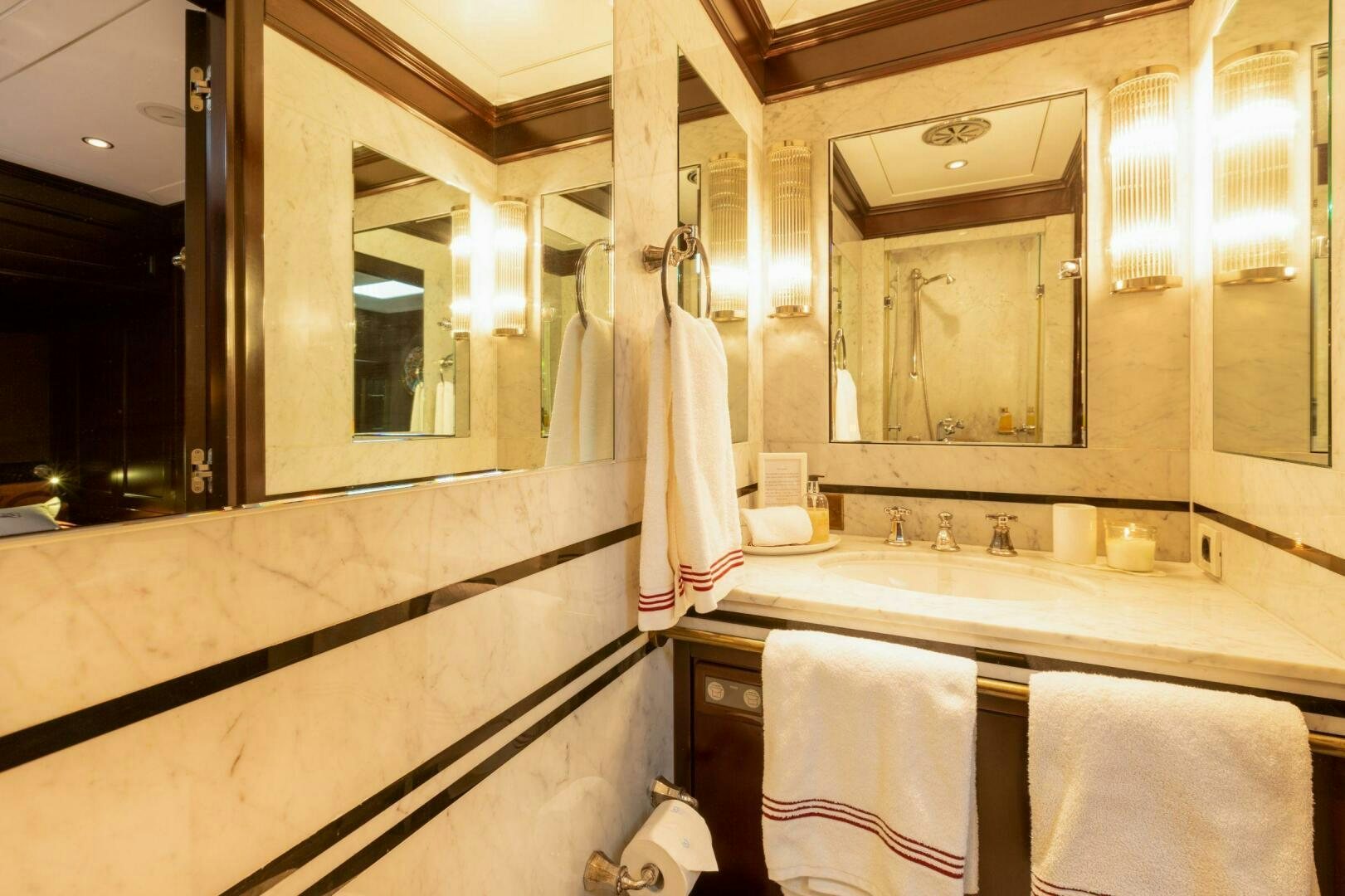 a bathroom with a large mirror aboard GWEILO Yacht for Sale