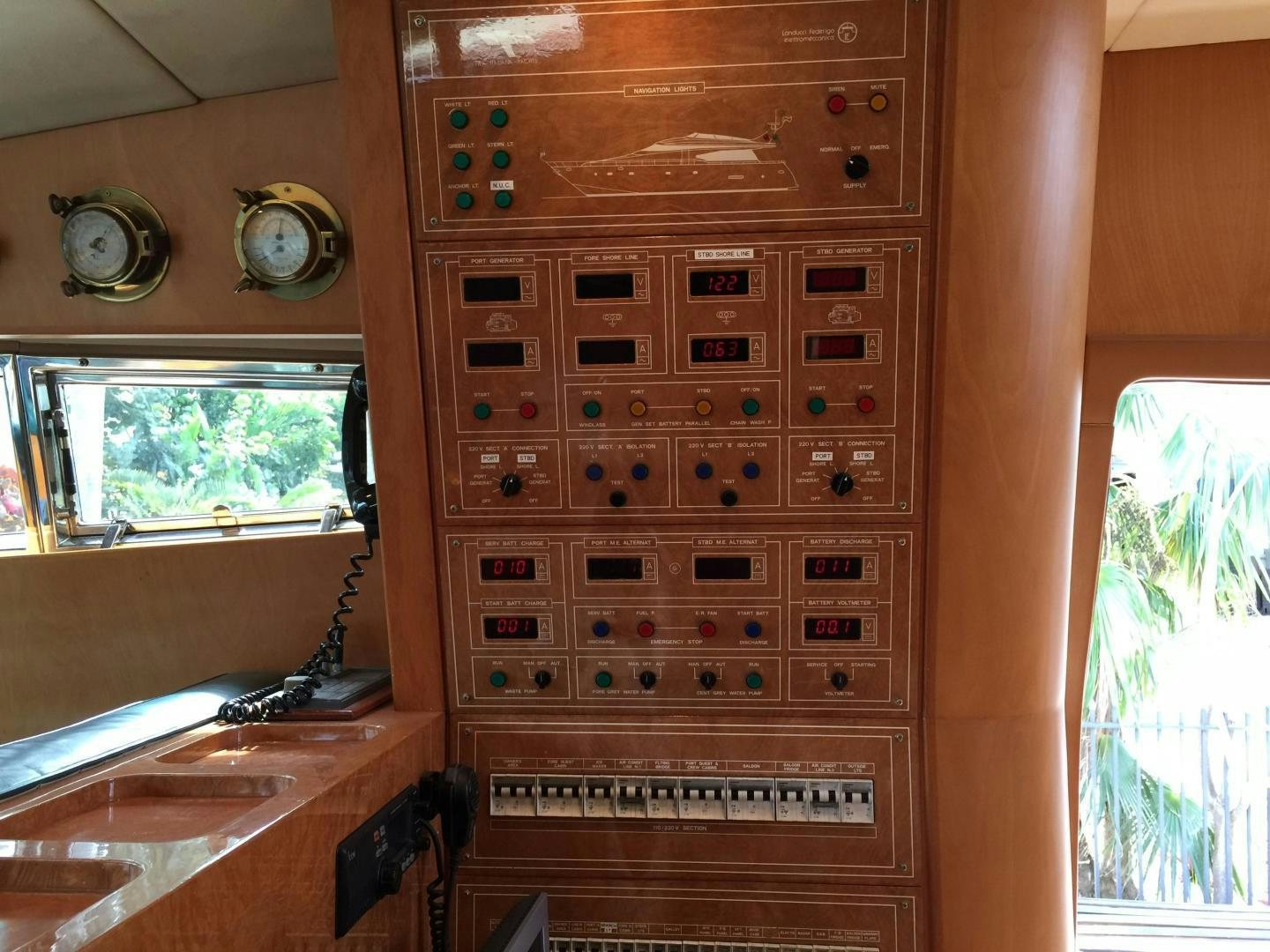 a wood cabinet with a clock on it aboard UNZIPPED Yacht for Sale