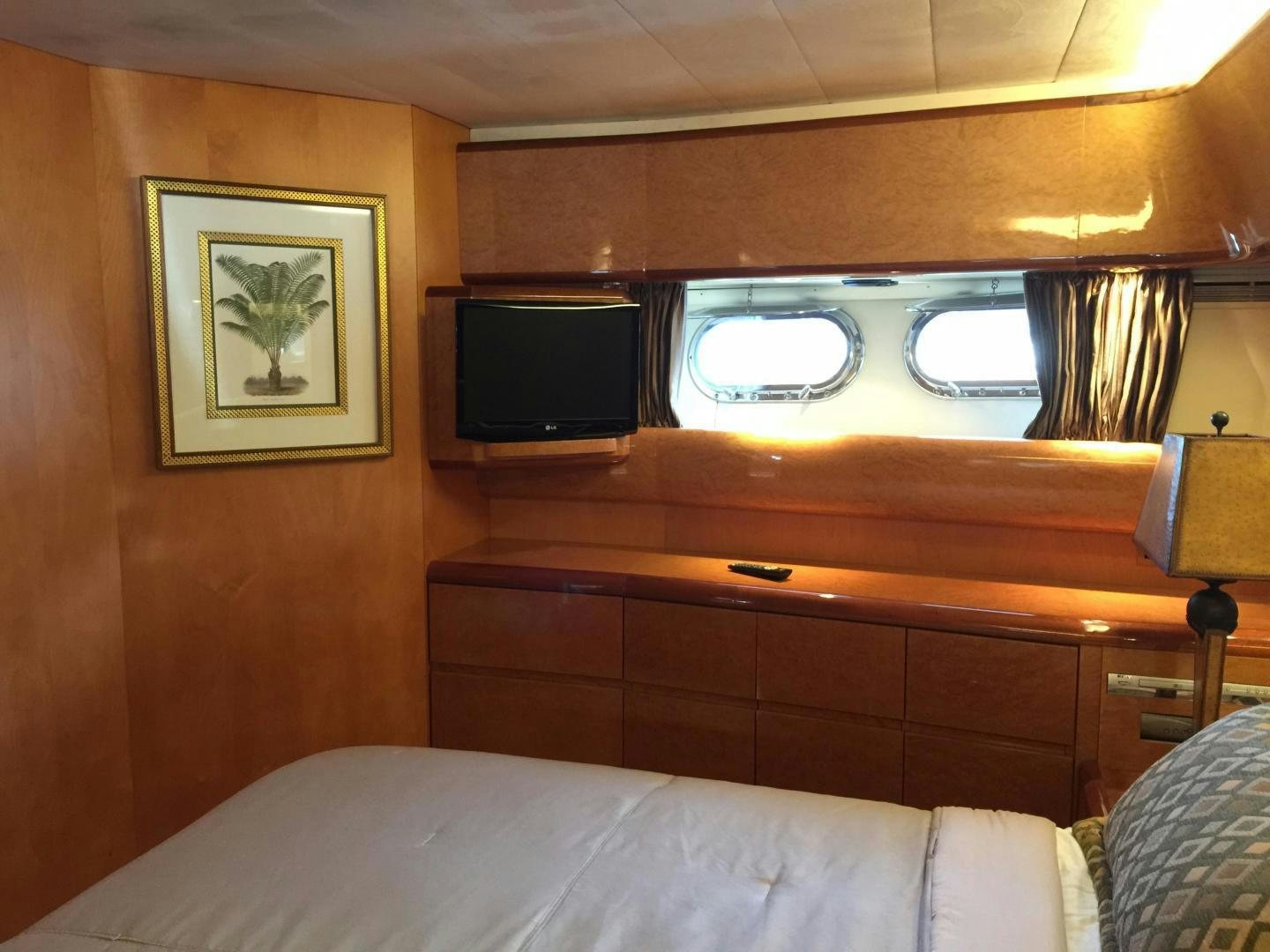 a bed with a television on the wall aboard UNZIPPED Yacht for Sale
