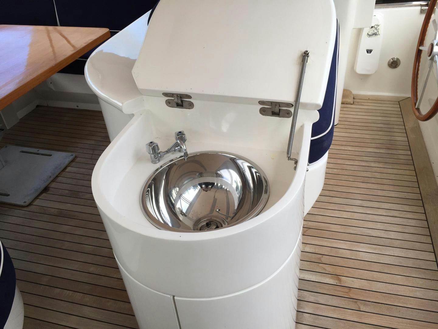 a toilet with a sink aboard UNZIPPED Yacht for Sale