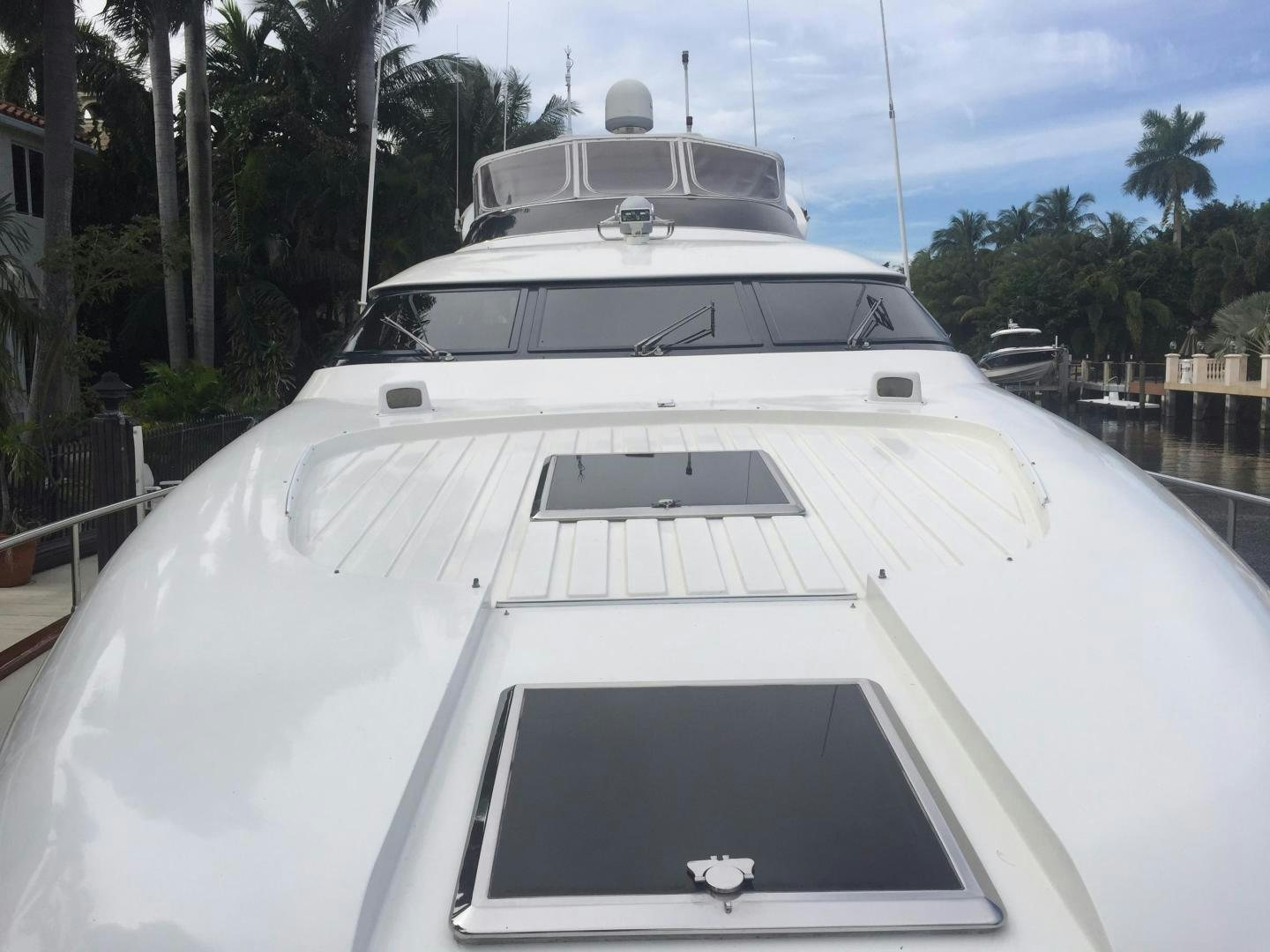 a white yacht on a dock aboard UNZIPPED Yacht for Sale