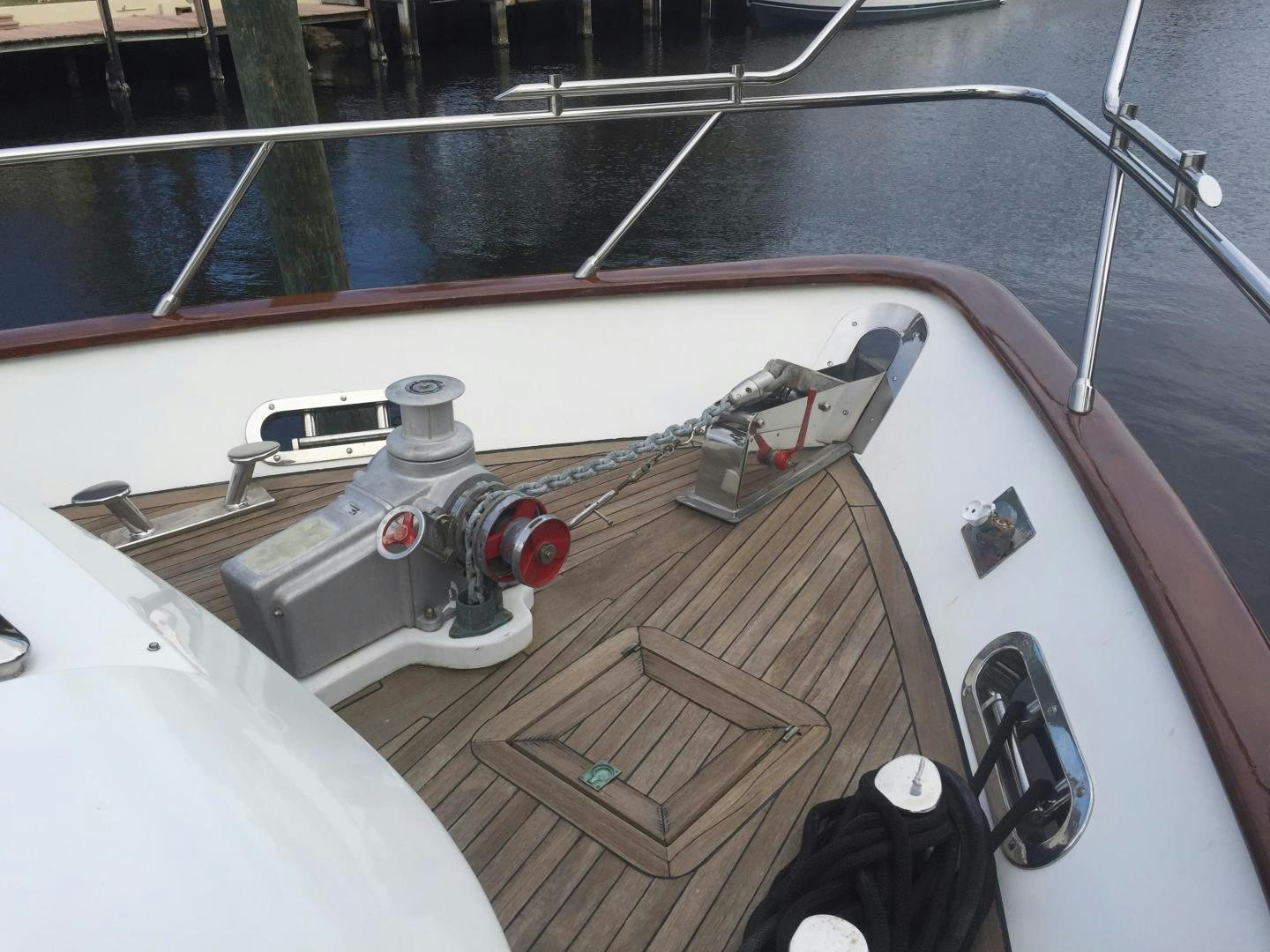 a boat with a deck and a deck and a railing aboard UNZIPPED Yacht for Sale