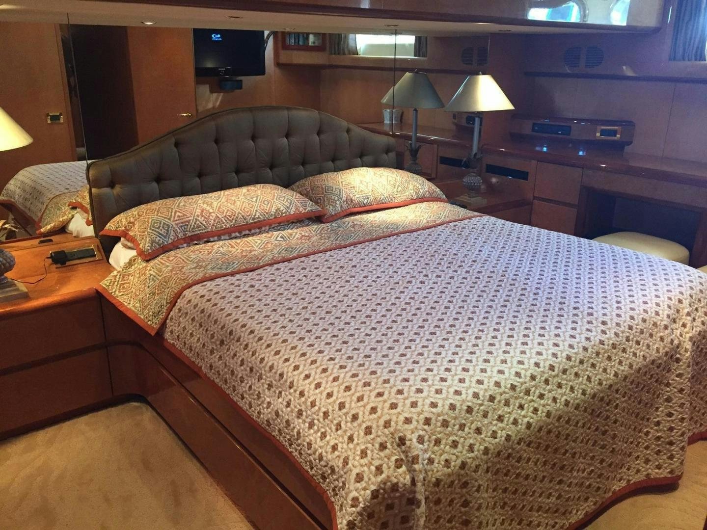a bed with a white comforter aboard UNZIPPED Yacht for Sale
