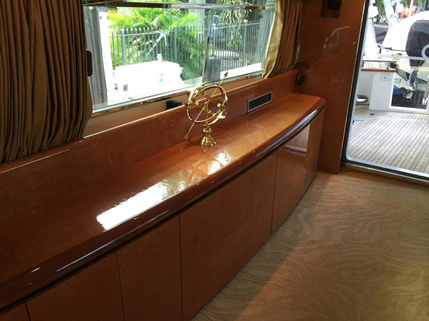 a wooden desk with a light aboard UNZIPPED Yacht for Sale