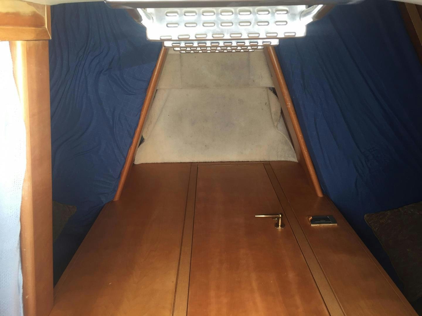 a room with a bed and a desk aboard UNZIPPED Yacht for Sale
