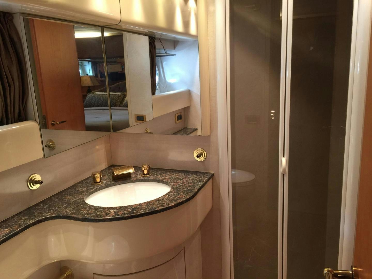 a bathroom with a sink and a large mirror aboard UNZIPPED Yacht for Sale