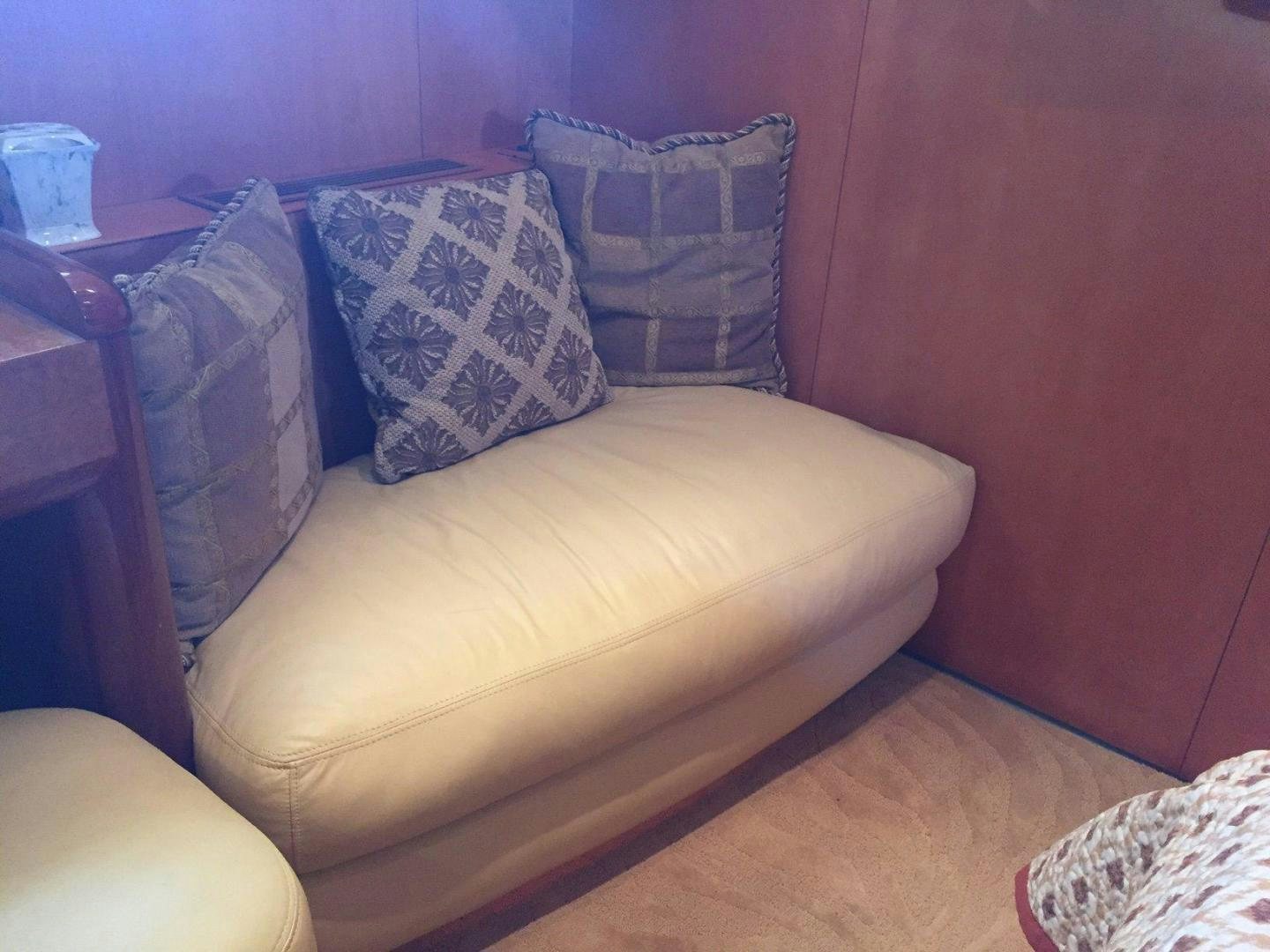 a couch with pillows aboard UNZIPPED Yacht for Sale