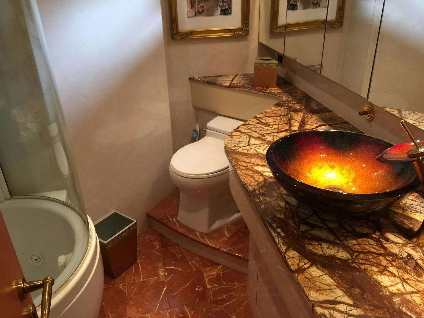 a large tub with a fire in it next to a toilet aboard UNZIPPED Yacht for Sale