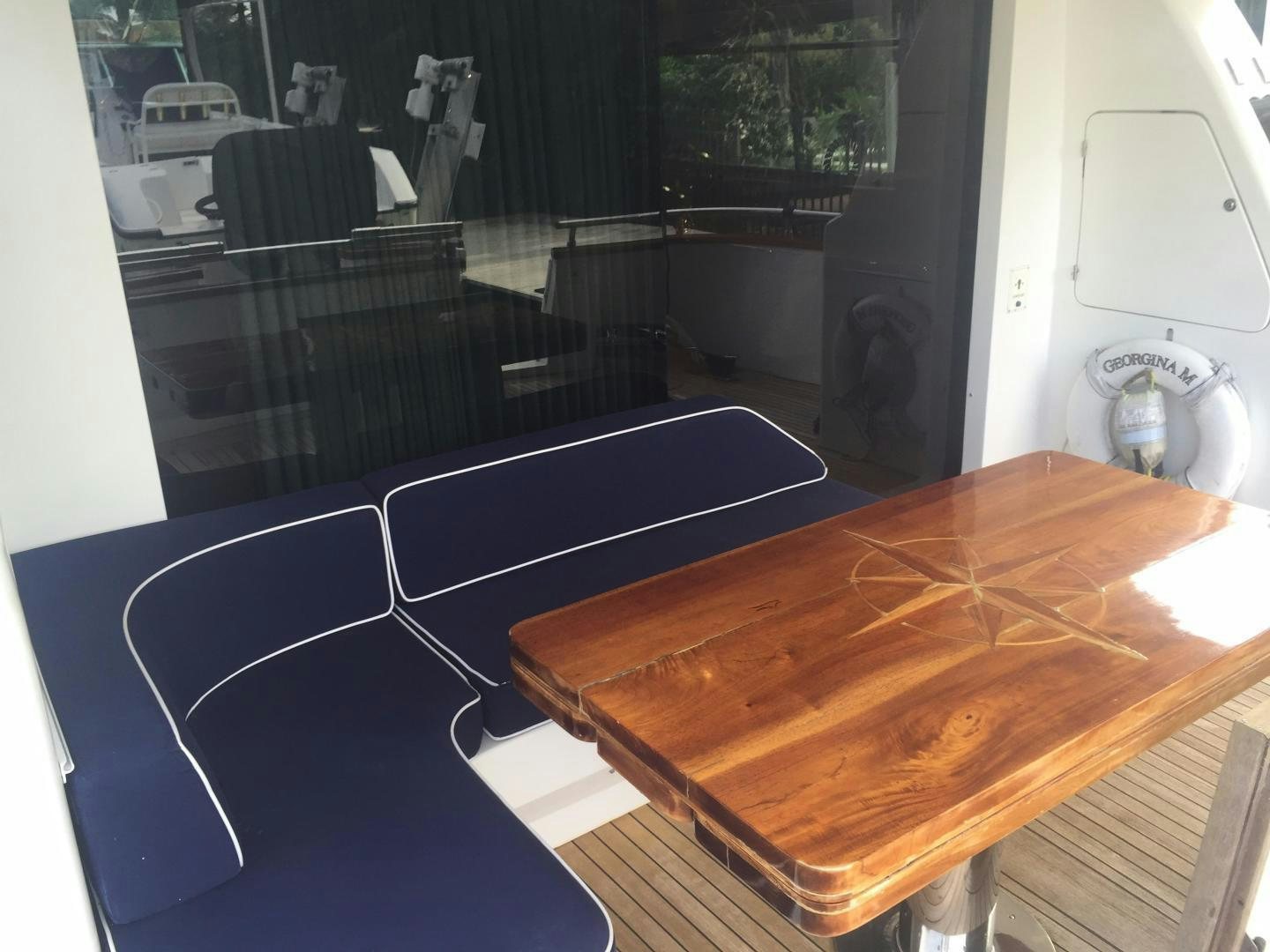 a table with a fan and a fan aboard UNZIPPED Yacht for Sale