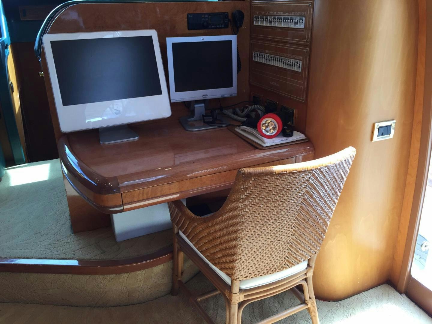 a couple of computer screens on a table aboard UNZIPPED Yacht for Sale