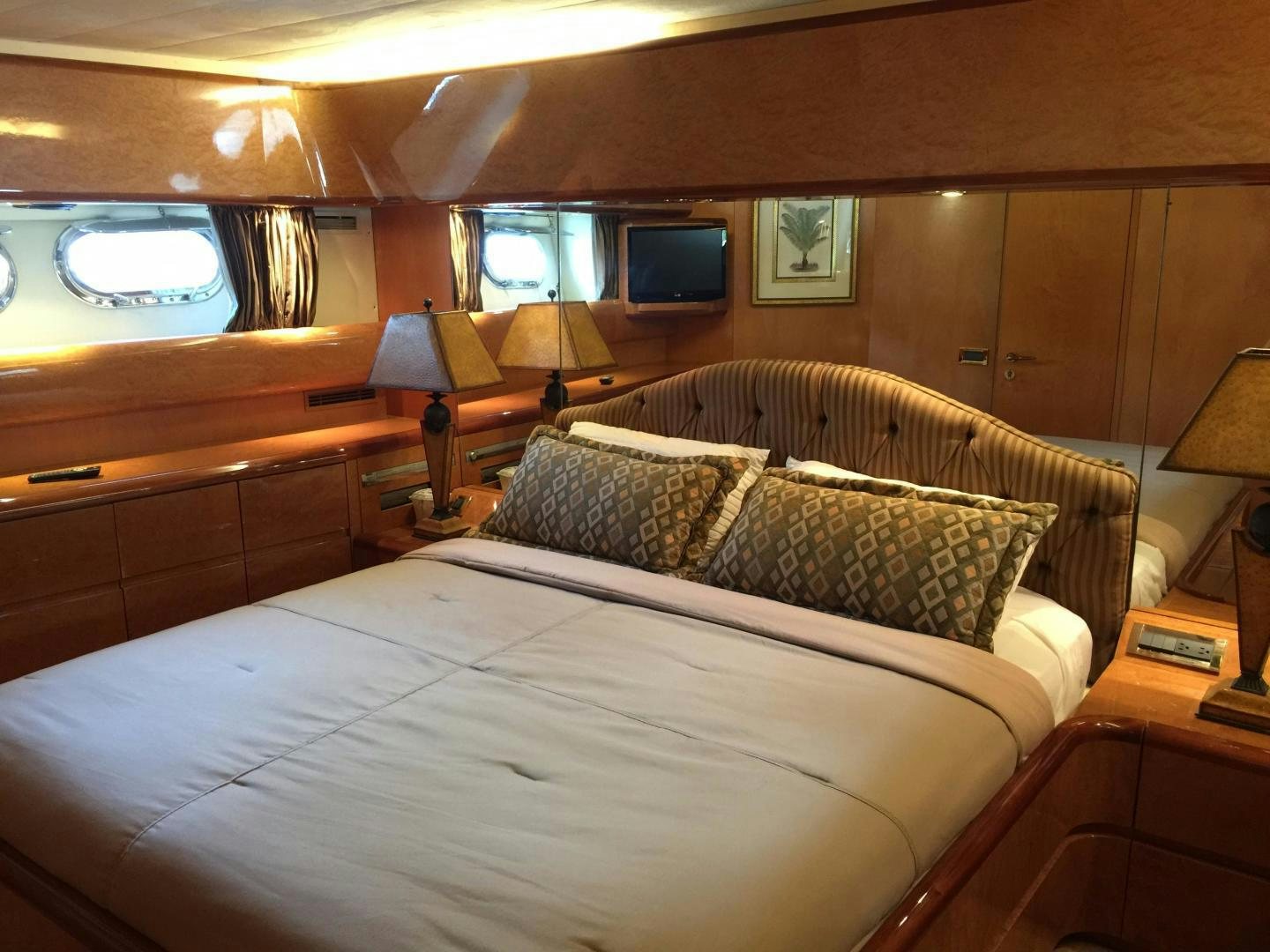 a bed with a white comforter aboard UNZIPPED Yacht for Sale