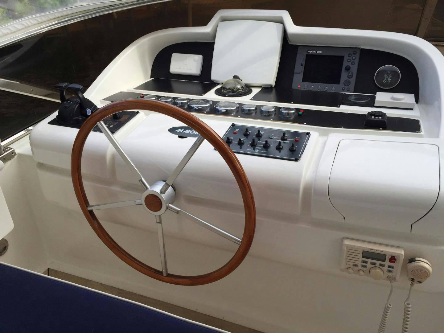 a white car with a steering wheel aboard UNZIPPED Yacht for Sale