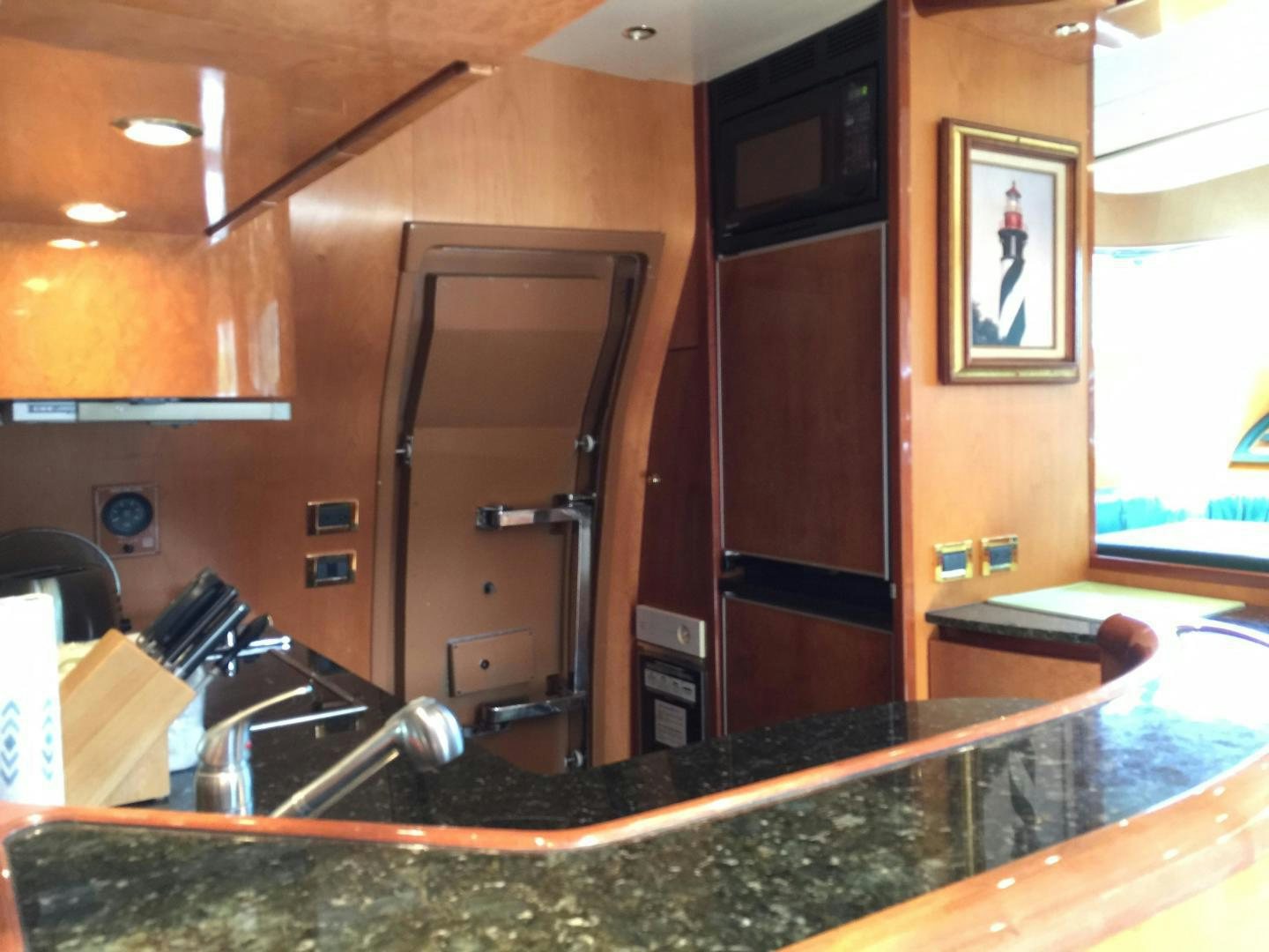 a kitchen with a large wooden door aboard UNZIPPED Yacht for Sale